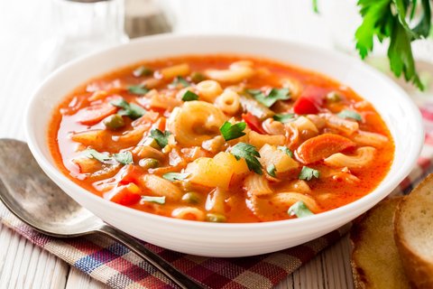 Eine Gemüsesuppe mit Nudeln in einem tiefen Teller