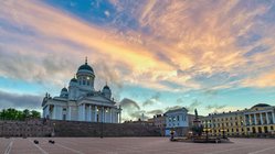 Von Helsinkis Senatsplatz blickt man auf den weißen klassizistischen Dom. Die im Bild befindliche  rechte Platzseite wird von ebenfalls klassizistischen Gebäuden flankiert.