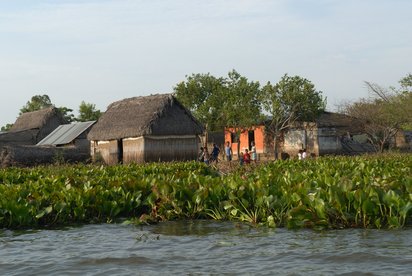 Kleines Dorf in Kolumbien Kleine Hütten und Kinder am Rande eines Flusses