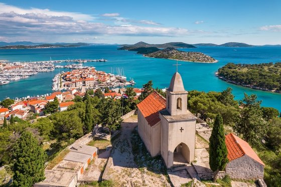 Historische Nikolauskirche in Tribunj, Kroatien, auf einem Hügel mit Blick auf das Meer. Die kleine Steinkirche besticht durch ihre schlichte Architektur und ihre markante Lage über der Küstenlandschaft.