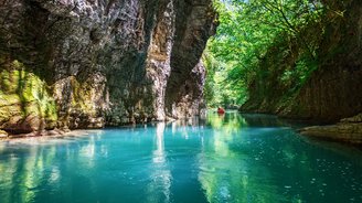 Mit Wasser gefüllte Schlucht, auf dem ein Kanu fährt